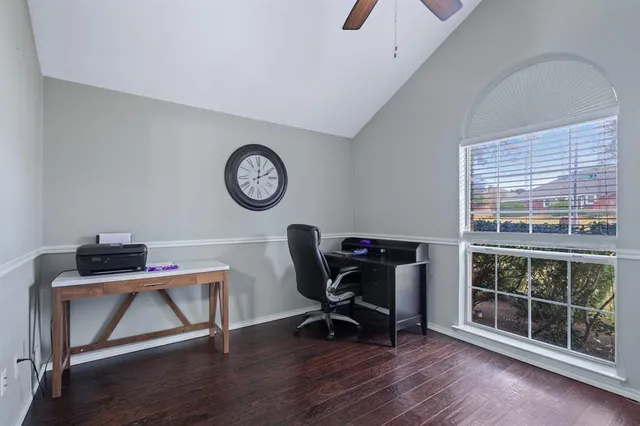 a view of a workspace with furniture and a window