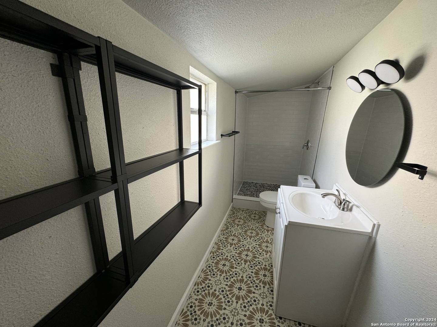 407 East Locust Street, Unit 10 San Antonio, TX 78212 - Photo 3 of 4 a bathroom with a sink and a mirror