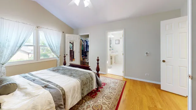 a spacious bedroom with a bed and a large window