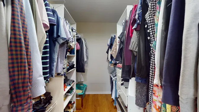 a view of walk in closet with clothes