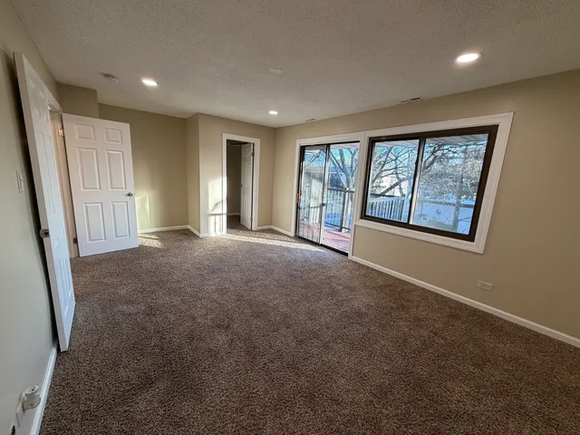an empty room with windows and closet