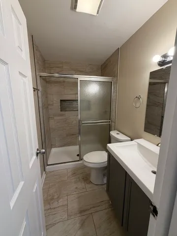 a bathroom with a toilet a sink and shower