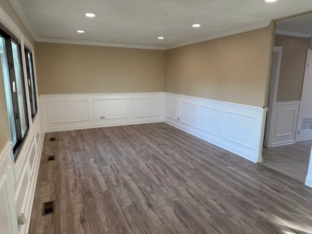 a view of room with window and wooden floor