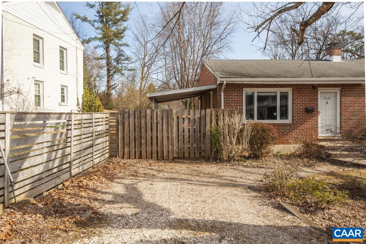 2600 Willard Drive Charlottesville, VA 22903 - Photo 43 of 47 a view of a house with a wooden fence and a floor to ceiling window
