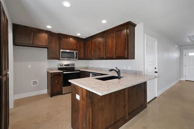 a kitchen with a sink and cabinets