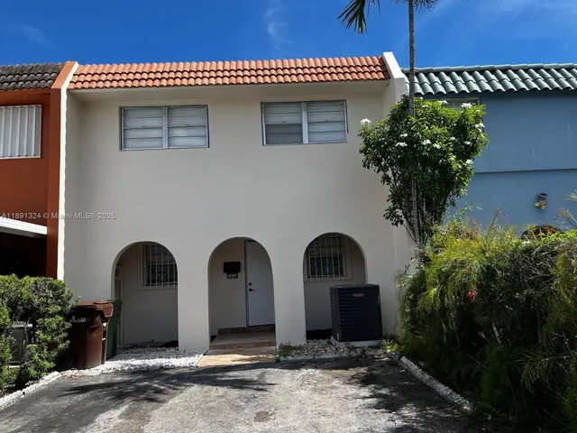 a front view of house with deck and outdoor seating