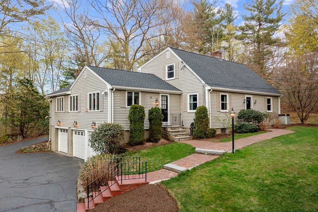 65 Charles River Street Needham, MA 02492 - Photo 1 of 21 a front view of a house with a yard and porch