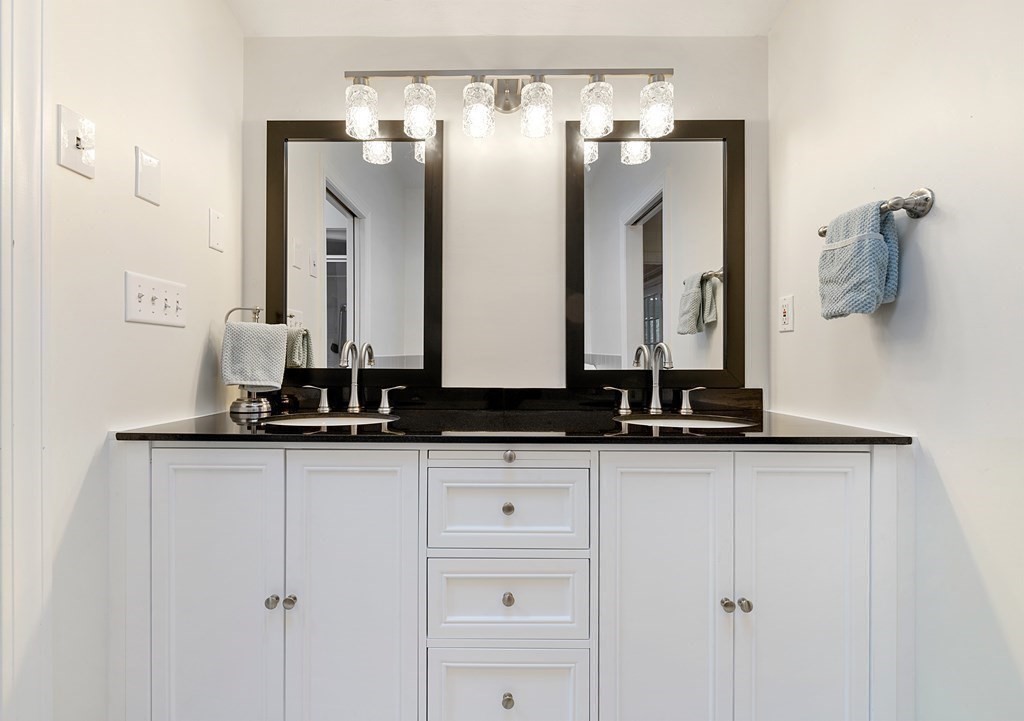 65 Charles River Street Needham, MA 02492 - Photo 11 of 21 a bathroom with a sink and a mirror