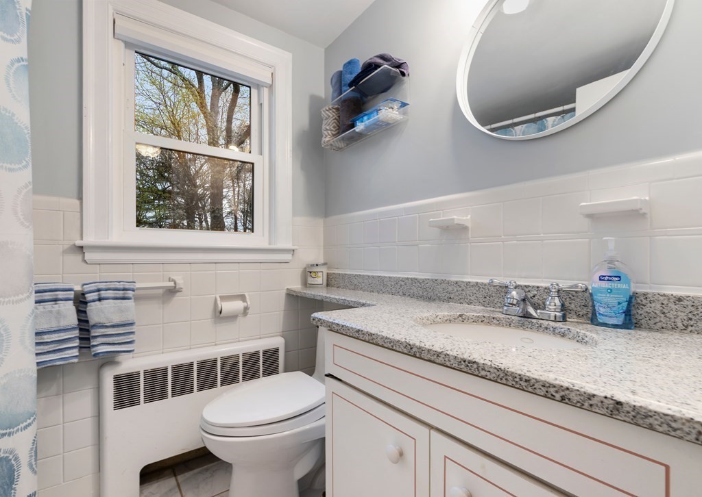 65 Charles River Street Needham, MA 02492 - Photo 16 of 21 a bathroom with a granite countertop toilet sink and mirror