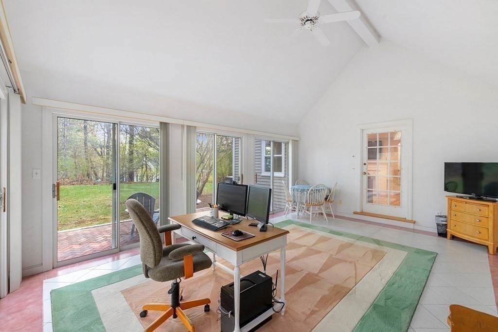65 Charles River Street Needham, MA 02492 - Photo 17 of 21 a living room with furniture a flat screen tv and a floor to ceiling window