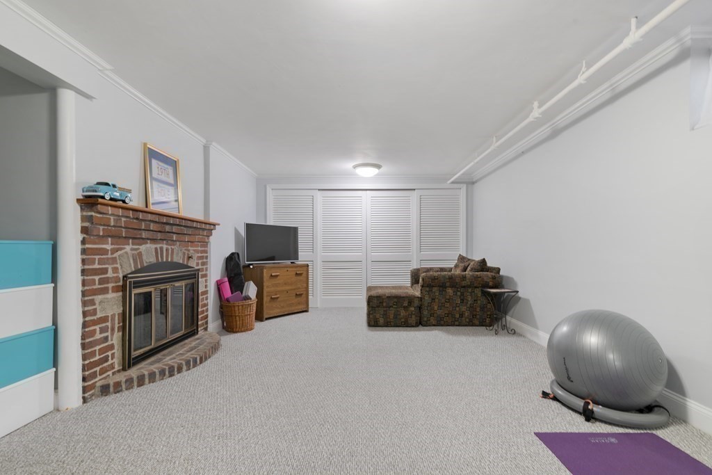 65 Charles River Street Needham, MA 02492 - Photo 19 of 21 a living room with furniture and a fireplace