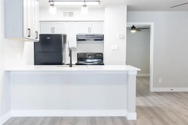 view of living room with cabinets and wooden floor