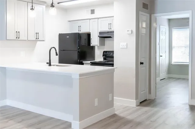 a kitchen with stainless steel appliances a refrigerator sink and cabinets
