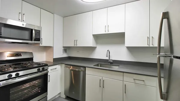 a kitchen with stainless steel appliances granite countertop a sink stove and microwave