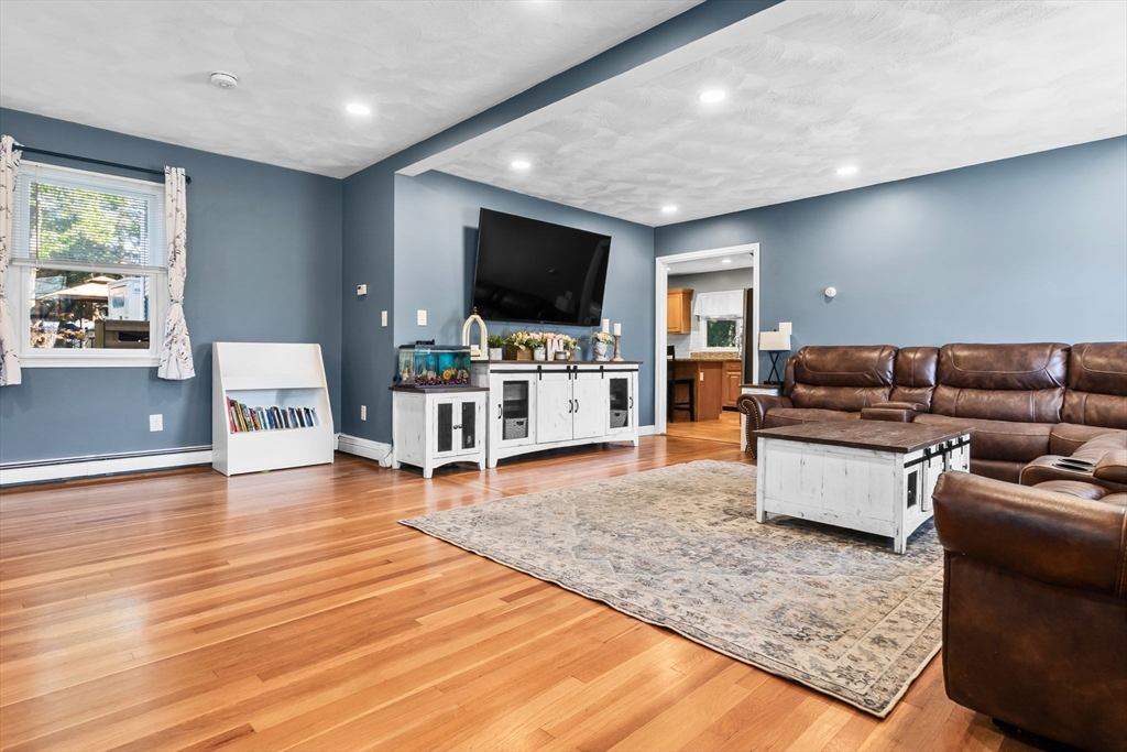 64 Vine Street Saugus, MA 01906 - Photo 11 of 42 a living room with furniture and a flat screen tv