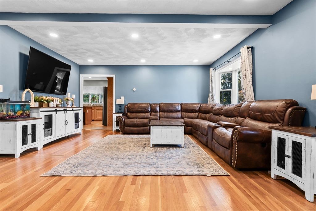 64 Vine Street Saugus, MA 01906 - Photo 12 of 42 a living room with furniture and a flat screen tv