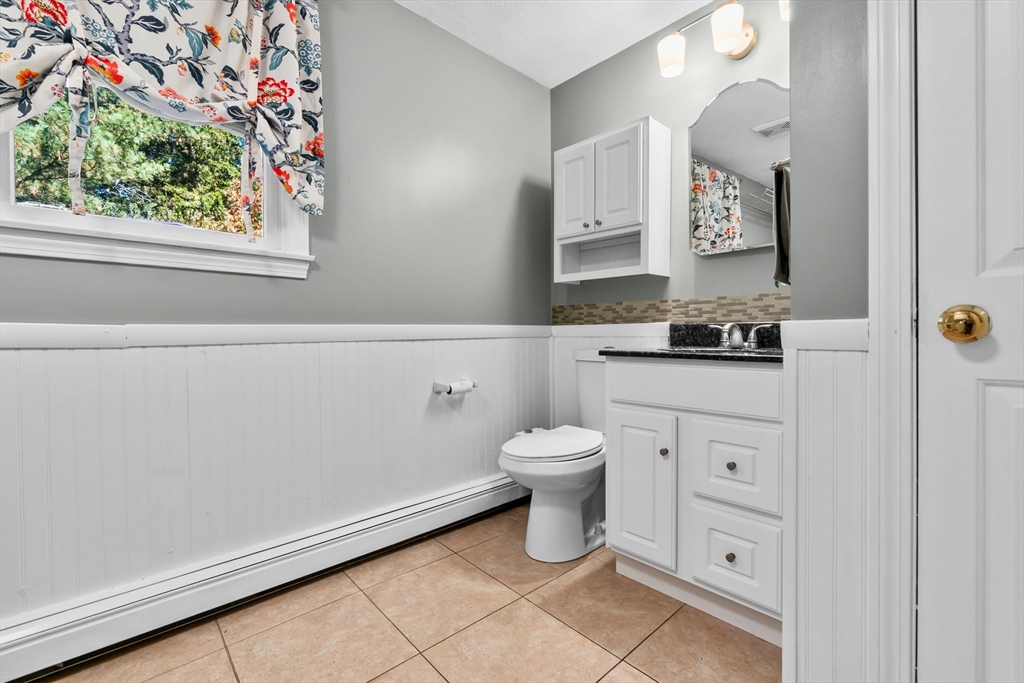 64 Vine Street Saugus, MA 01906 - Photo 15 of 42 a bathroom with a toilet a sink and a mirror