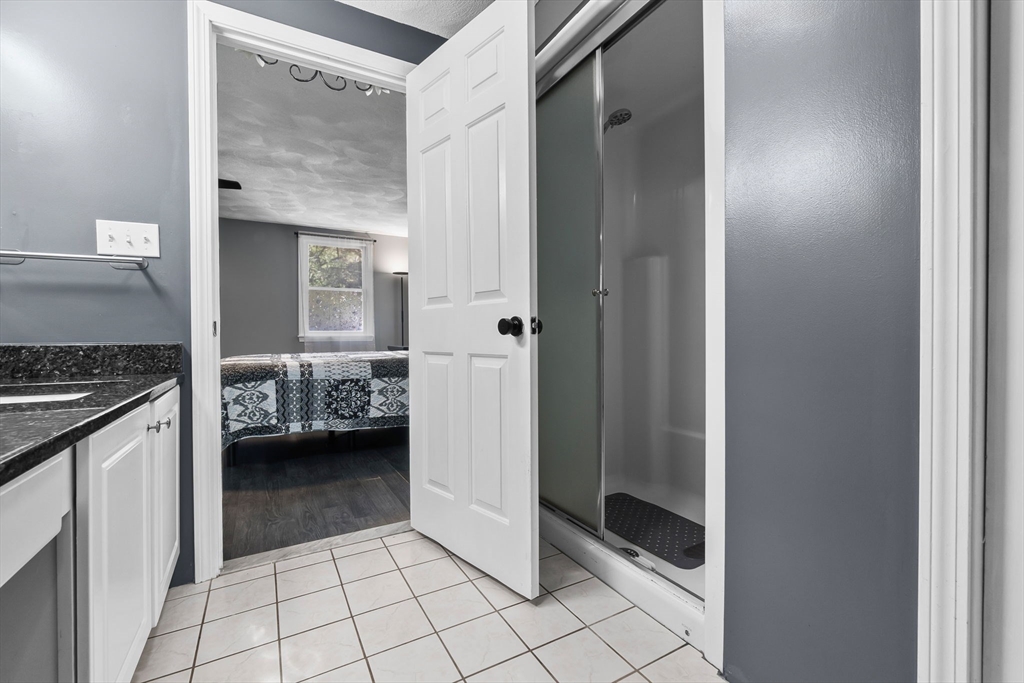 64 Vine Street Saugus, MA 01906 - Photo 17 of 42 a view of a bathroom with a sink and a mirror