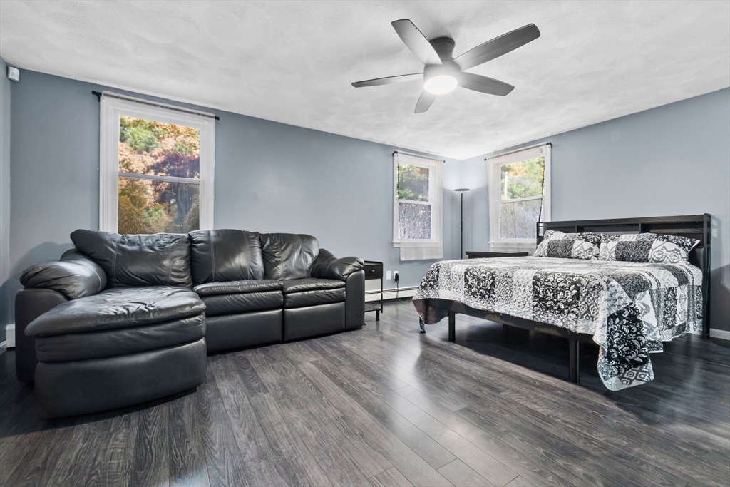 64 Vine Street Saugus, MA 01906 - Photo 18 of 42 a bedroom with a large bed a couch and a window