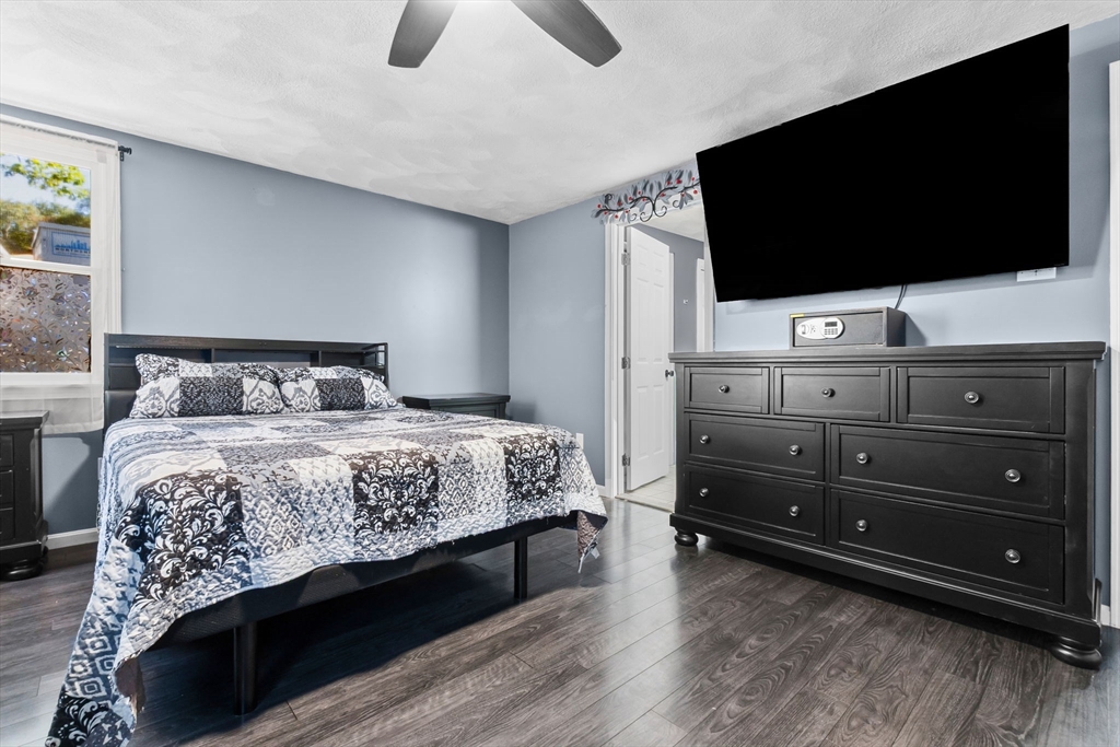 64 Vine Street Saugus, MA 01906 - Photo 19 of 42 a bedroom with a bed and a flat screen tv