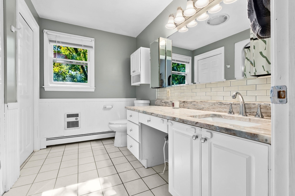 64 Vine Street Saugus, MA 01906 - Photo 21 of 42 a bathroom with a sink a vanity and a mirror