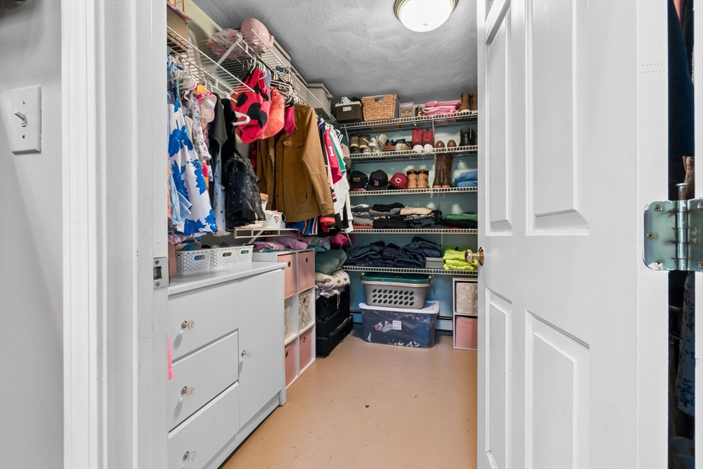 64 Vine Street Saugus, MA 01906 - Photo 22 of 42 a view of walk in closet with clothes and shoes