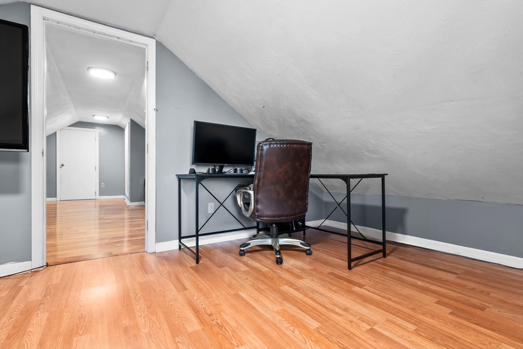 64 Vine Street Saugus, MA 01906 - Photo 25 of 42 a view of a livingroom with wooden floor and a flat screen tv