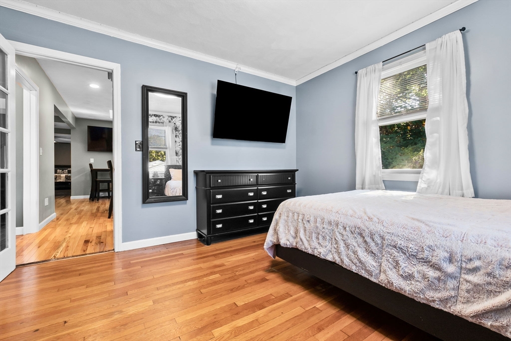 64 Vine Street Saugus, MA 01906 - Photo 8 of 42 a bedroom with a bed and a flat screen tv