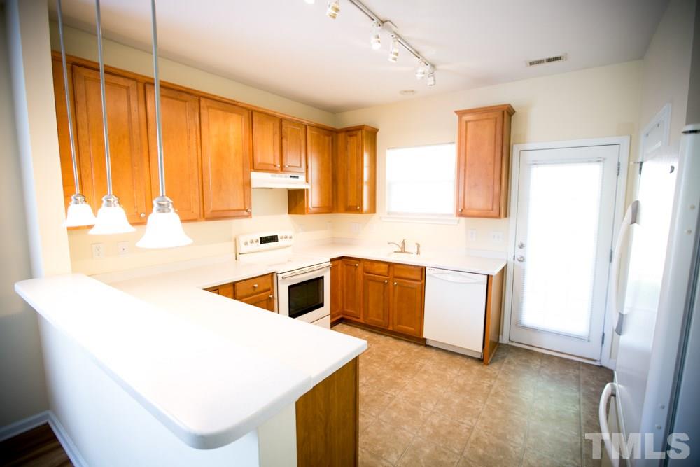 3214 Ranbir Drive Durham, NC 27713 - Photo 2 of 20 a kitchen with a stove a sink and a refrigerator