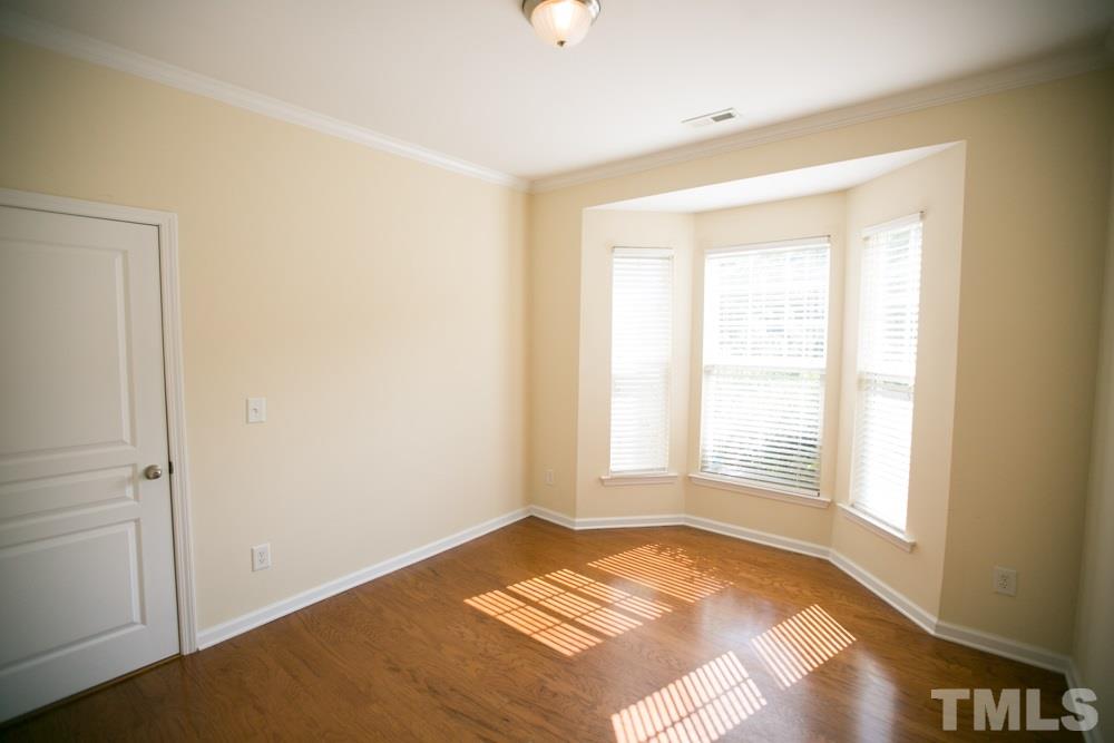 3214 Ranbir Drive Durham, NC 27713 - Photo 13 of 20 a view of a bedroom with wooden floor and windows