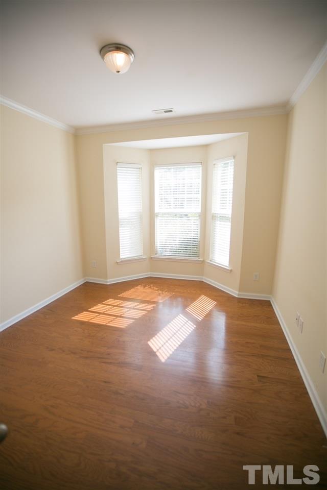 3214 Ranbir Drive Durham, NC 27713 - Photo 14 of 20 an empty room with wooden floor and windows