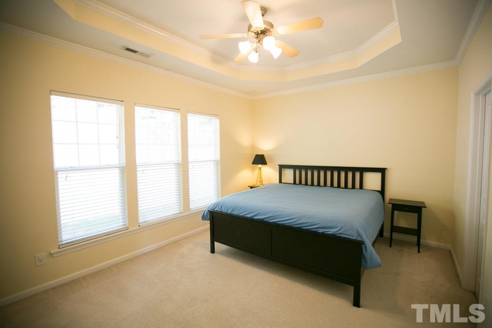 3214 Ranbir Drive Durham, NC 27713 - Photo 15 of 20 a bed sitting in a spacious bedroom next to a window