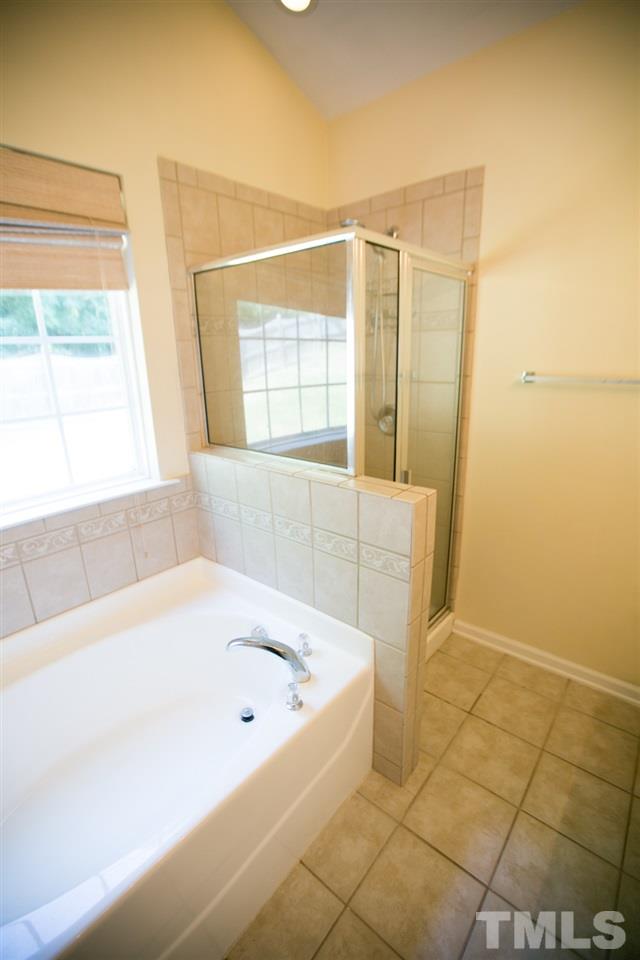3214 Ranbir Drive Durham, NC 27713 - Photo 17 of 20 a bathroom with a bathtub and shower