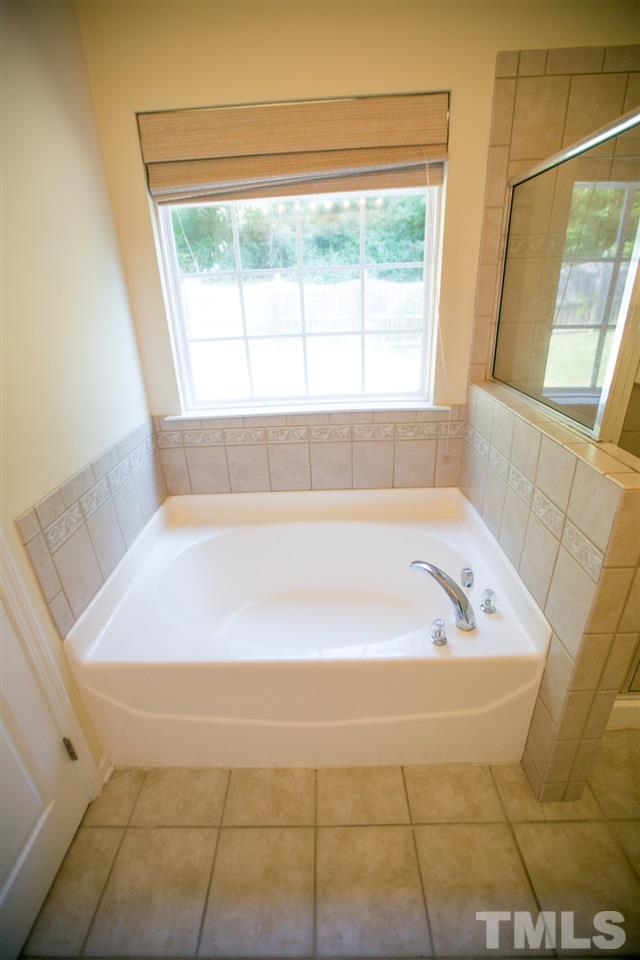 3214 Ranbir Drive Durham, NC 27713 - Photo 18 of 20 a bath tub sitting in a bathroom next to a window