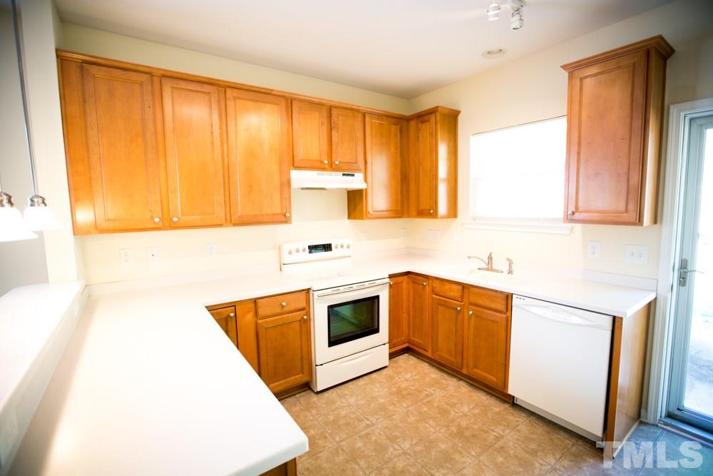 3214 Ranbir Drive Durham, NC 27713 - Photo 3 of 20 a kitchen with stainless steel appliances a stove a sink and a microwave