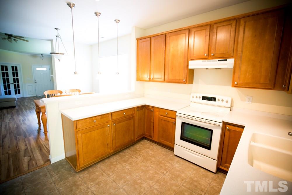 3214 Ranbir Drive Durham, NC 27713 - Photo 4 of 20 a kitchen with a stove and a microwave