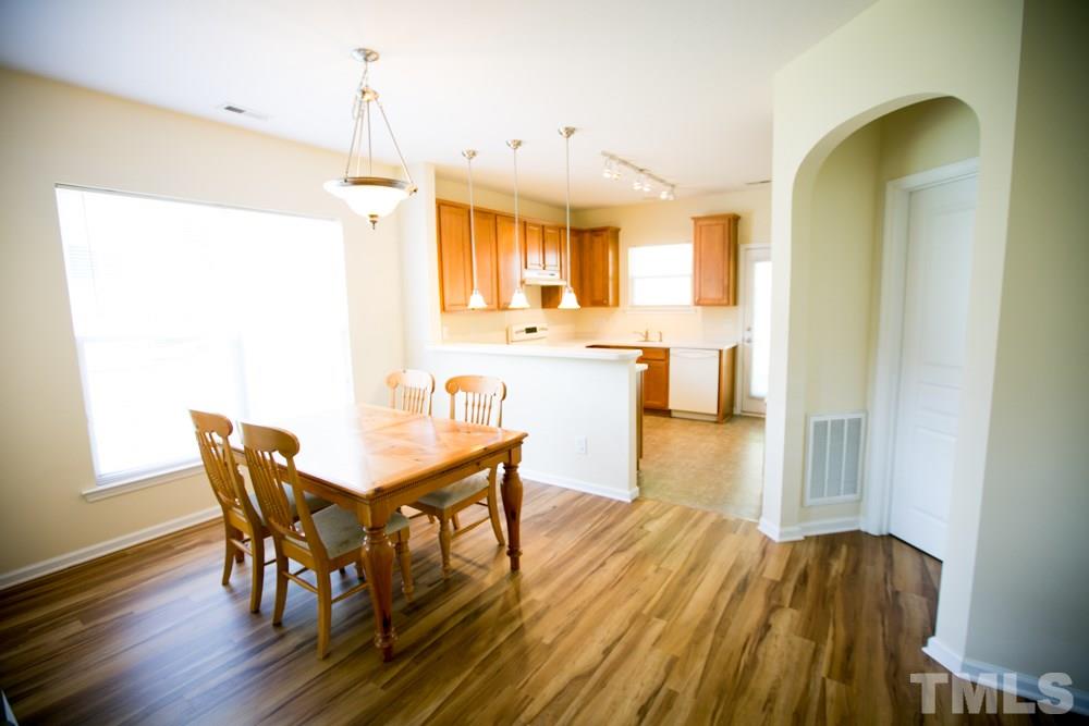 3214 Ranbir Drive Durham, NC 27713 - Photo 5 of 20 a view of a dining room with furniture and wooden floor