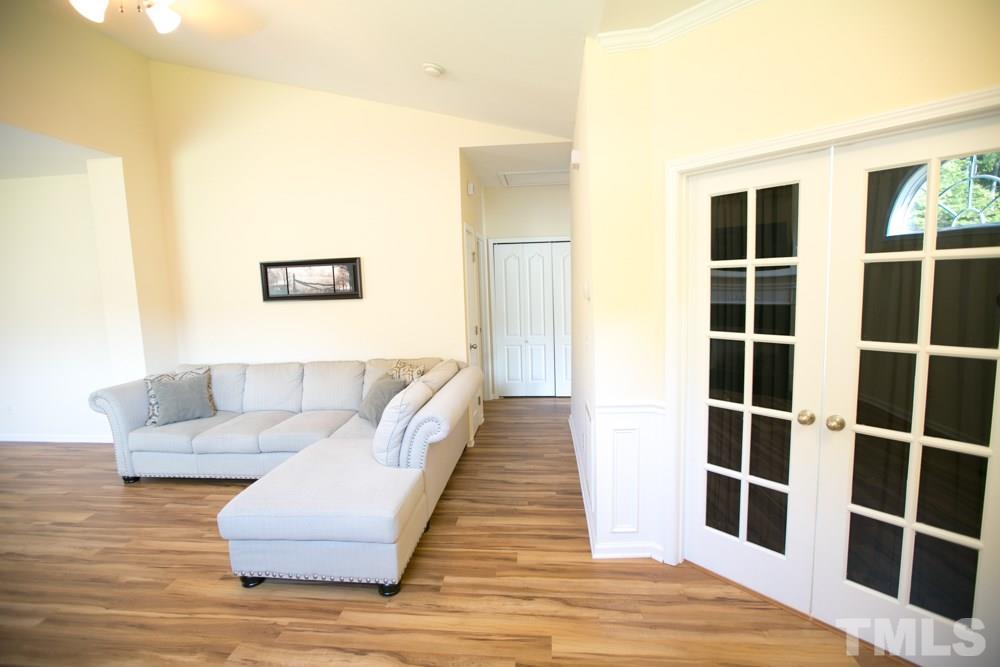 3214 Ranbir Drive Durham, NC 27713 - Photo 8 of 20 a living room with a couch and a wooden floor