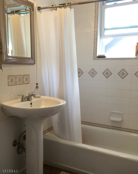 12 Orchard Road, Unit 2 Maplewood, NJ 07040 - Photo 10 of 11 a bathroom with a sink and a bathtub