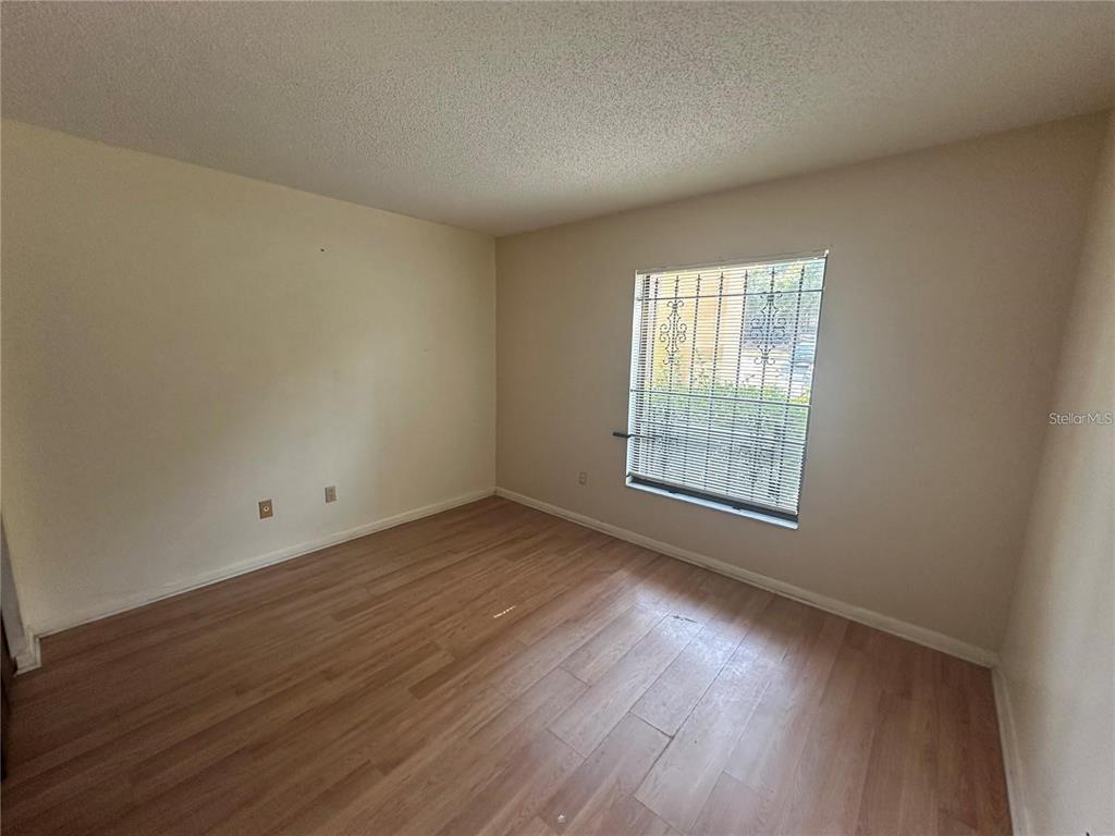 600 Cranes Way, Unit 103 Altamonte Springs, FL 32701 - Photo 12 of 17 a view of an empty room with wooden floor and a window