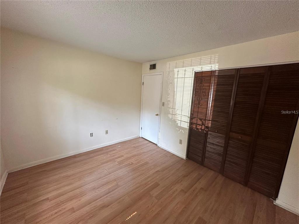 600 Cranes Way, Unit 103 Altamonte Springs, FL 32701 - Photo 13 of 17 a view of empty room with wooden floor and cabinet