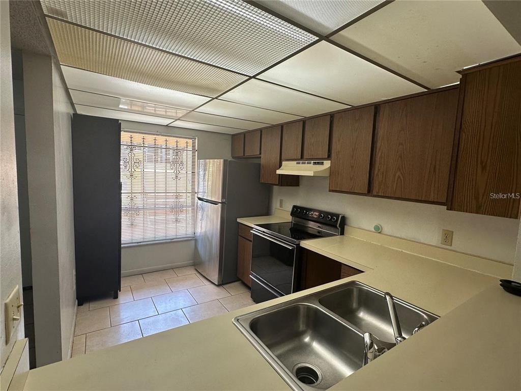 600 Cranes Way, Unit 103 Altamonte Springs, FL 32701 - Photo 4 of 17 a kitchen with stainless steel appliances granite countertop a sink a stove and a refrigerator