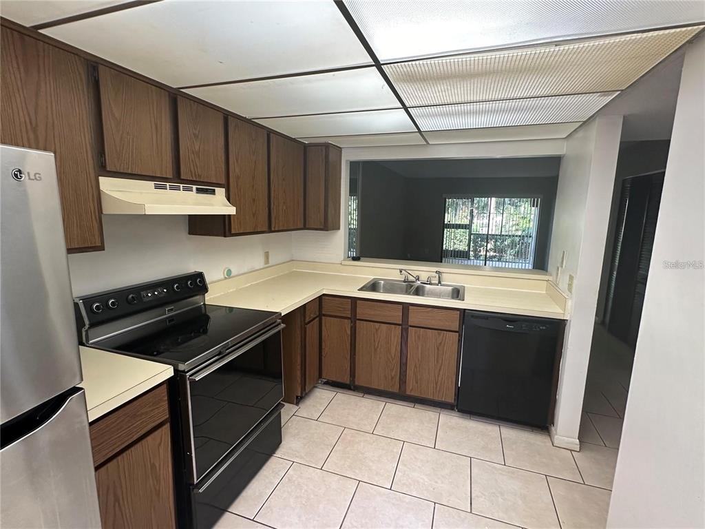600 Cranes Way, Unit 103 Altamonte Springs, FL 32701 - Photo 5 of 17 a kitchen with a sink and a stove top oven