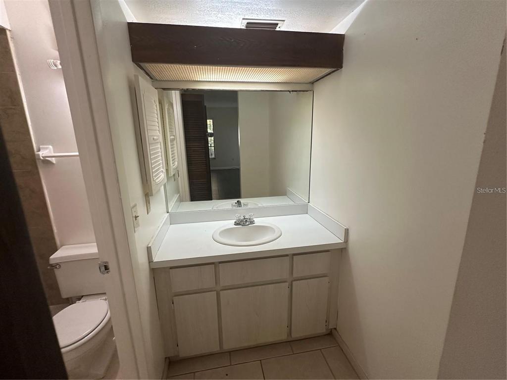 600 Cranes Way, Unit 103 Altamonte Springs, FL 32701 - Photo 10 of 17 a bathroom with a toilet sink and mirror
