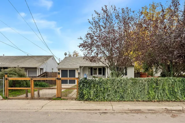 a front view of a house with a garden