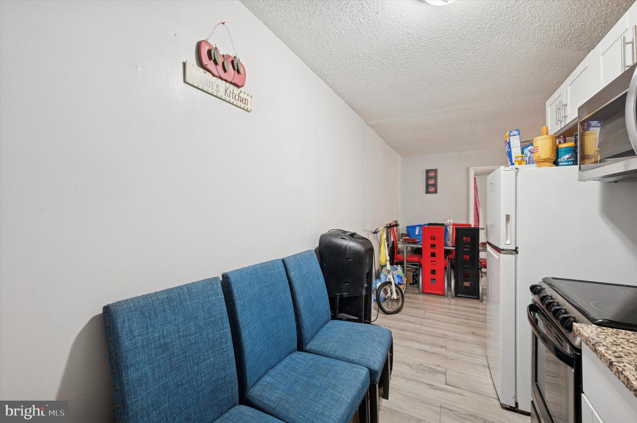 425 Main Street Darby, PA 19023 - Photo 11 of 18 a living room with furniture a refrigerator and a couch