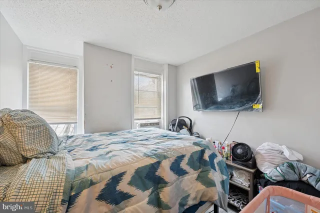 a bedroom with a bed and a flat screen tv