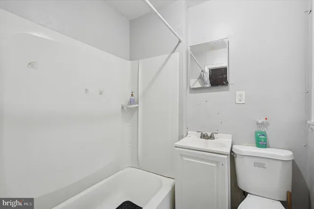 a bathroom with a sink toilet and tub