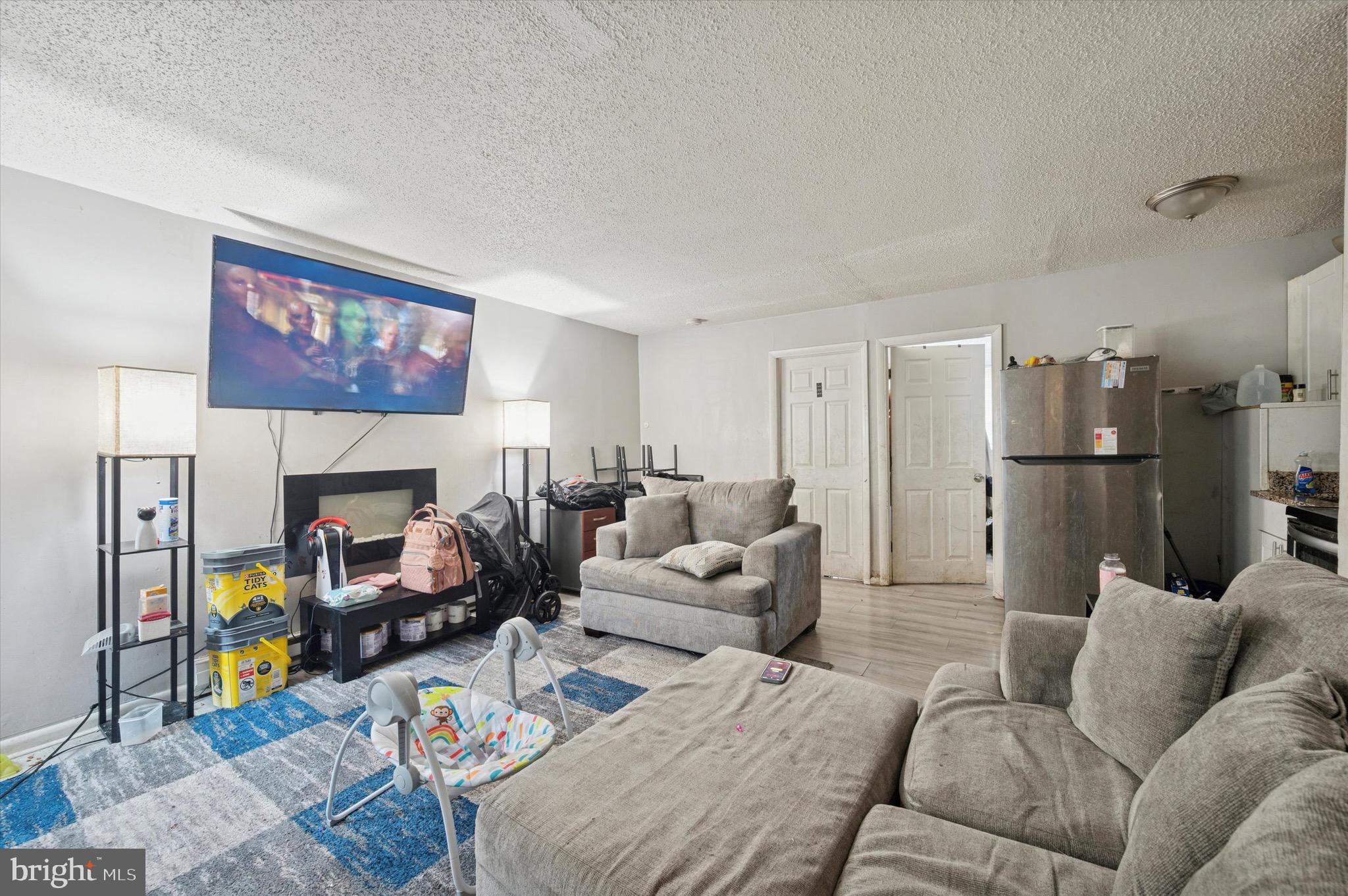 425 Main Street Darby, PA 19023 - Photo 14 of 18 a living room with furniture a fireplace and a flat screen tv