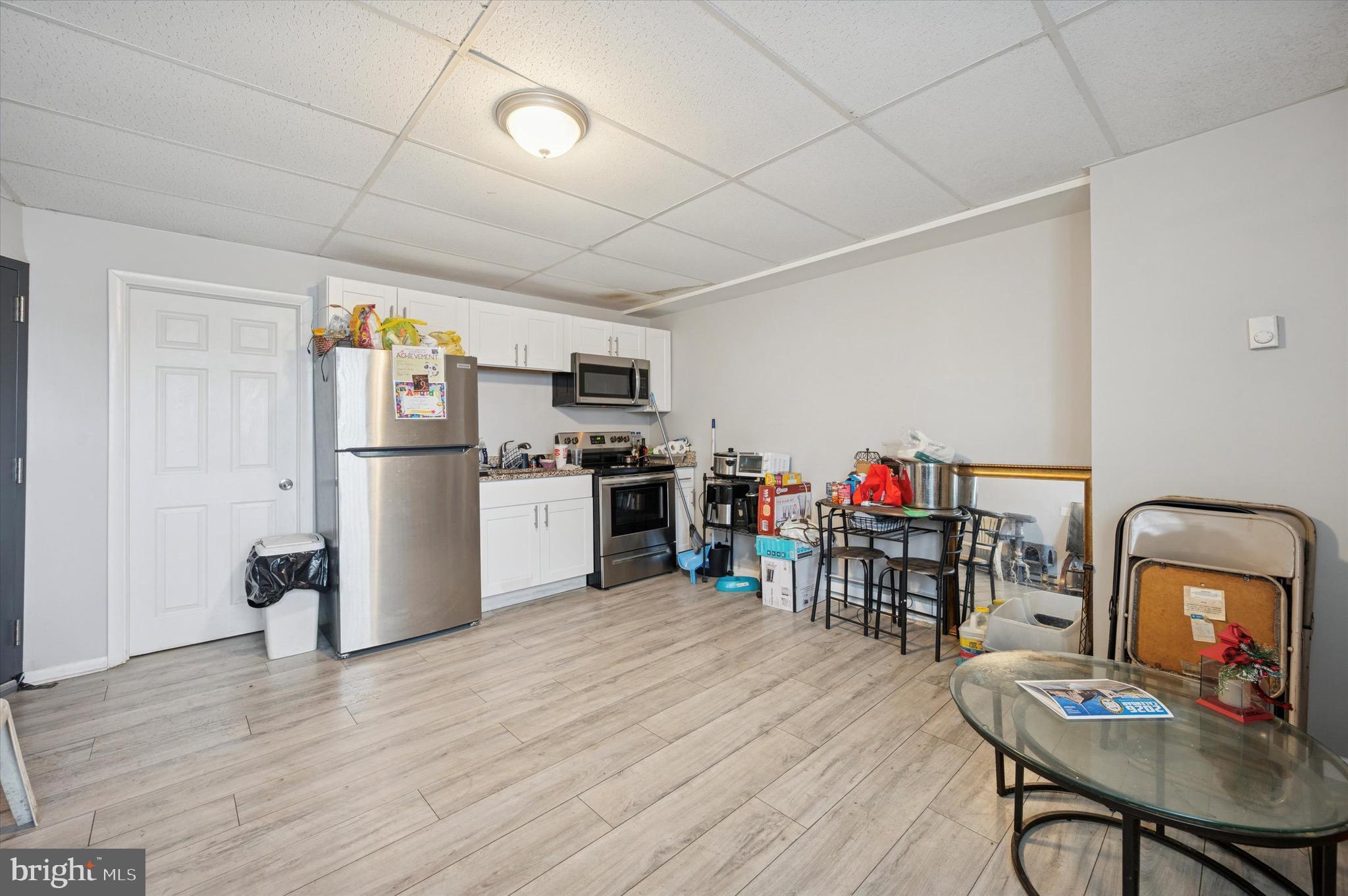 425 Main Street Darby, PA 19023 - Photo 4 of 18 a kitchen with stainless steel appliances a refrigerator and wooden floor